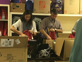 PDA Advisory Committee members Kathy Lee-Cornell and Jeff Holland pack backpacks at the IWC center in San Antonio