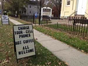 Sign saying charge your cell phones; hot coffee