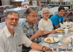 four volunteers eating at a table; photo by Sally W. Stoecker