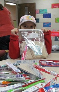 child with hygiene kit in bag
