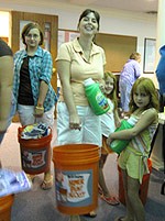 women holding buckets and detergent