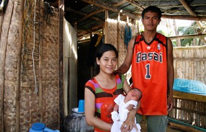 mother, father, and infant; photo by Christian Aid/ACT