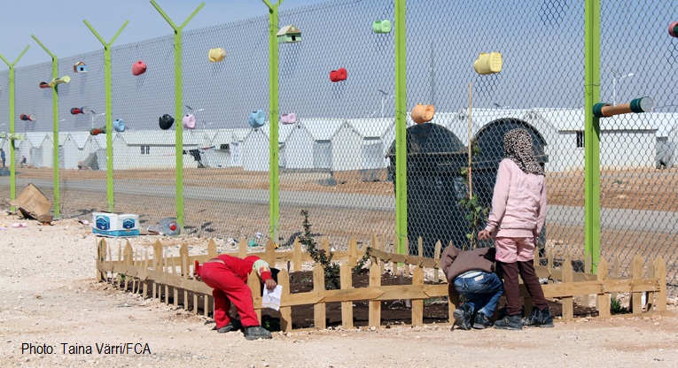 refugees working in refugee camp garden