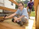 youth volunteer staining a deck