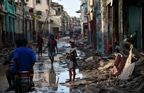 A girl walks on a street damaged in hurricane Matthew, in Jeremie, in western Haiti, on October 7, 2016. The full scale of the devastation in hurricane-hit rural Haiti became clear as the death toll surged over 400, three days after Hurricane Matthew leveled huge swaths of the country's south.