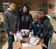 youth behind boxes of kit supplies