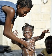 mother washes child with soap