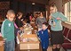 children and adults with boxes of kit supplies